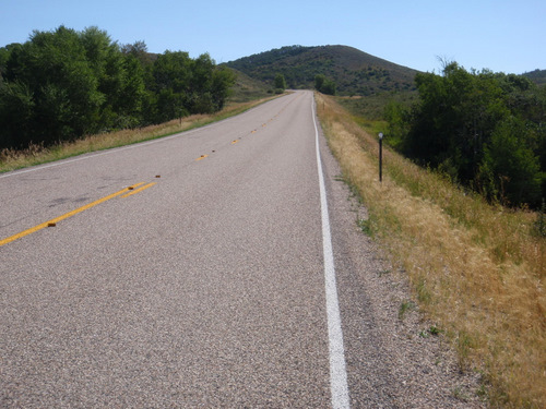  A look up the road with more short wheat on the roadside.